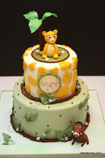 a baby shower cake with a teddy bear on top