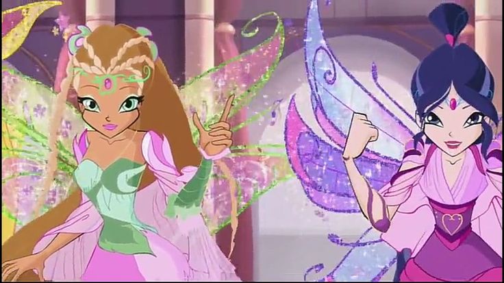 two girls dressed in fairy costumes and one is pointing to the side with her hand