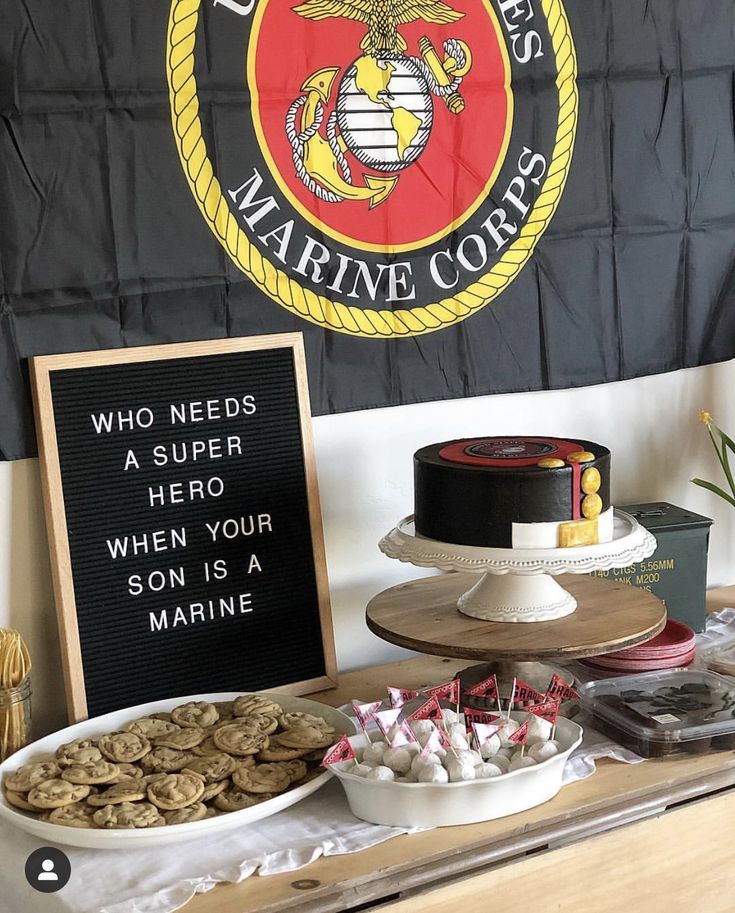 the dessert table is set up with cookies and cakes for us marine forces birthday party