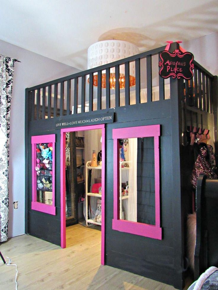 the inside of a dollhouse with pink and black trimmings on the doors