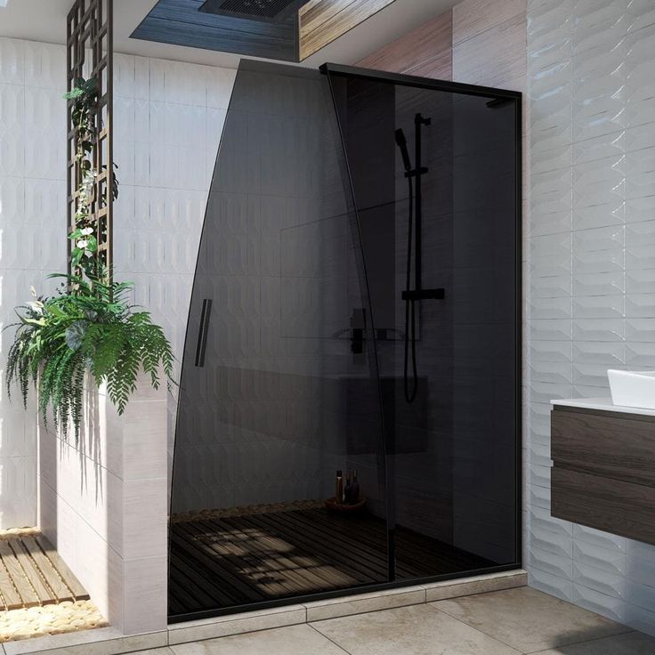 a bathroom with a walk in shower next to a plant