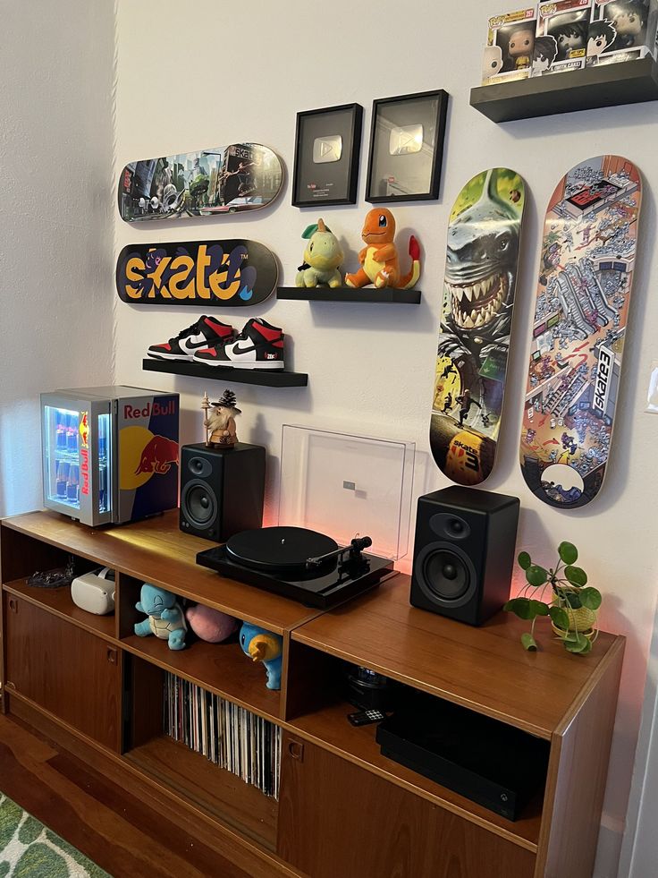 there are many skateboards on the wall above this entertainment center with speakers and bookshelves