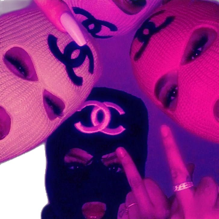 three people wearing pink and black masks with their fingers in the air, making peace signs