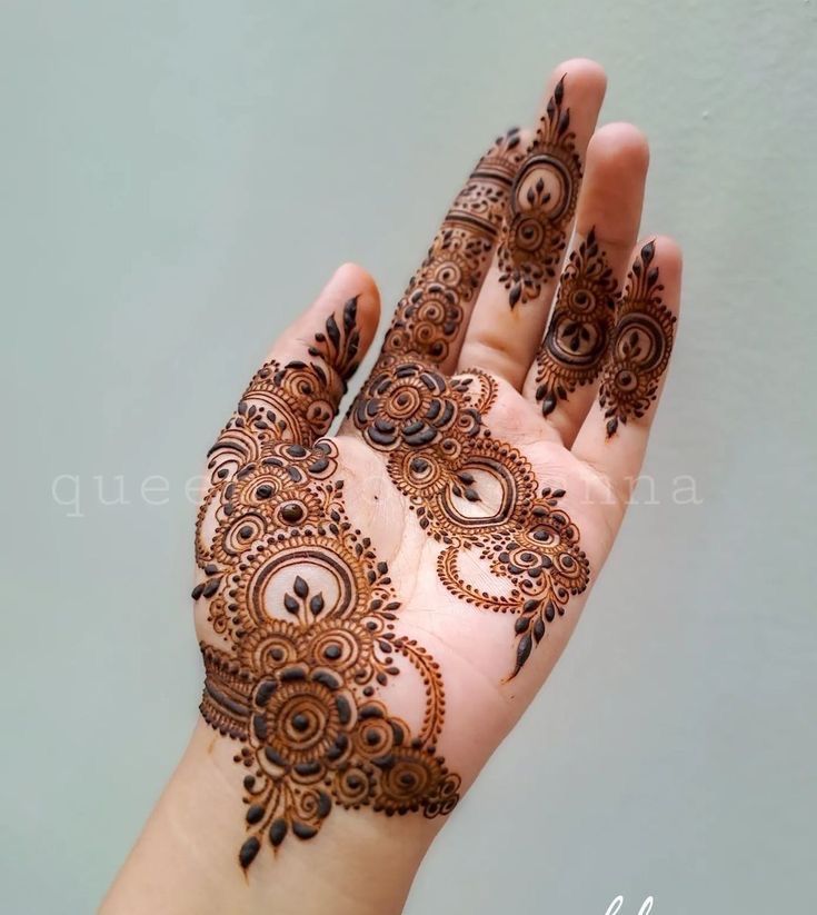 the hand is decorated with henna on it