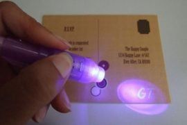 a person is holding a purple light in their left hand and the other one has an electronic device attached to it