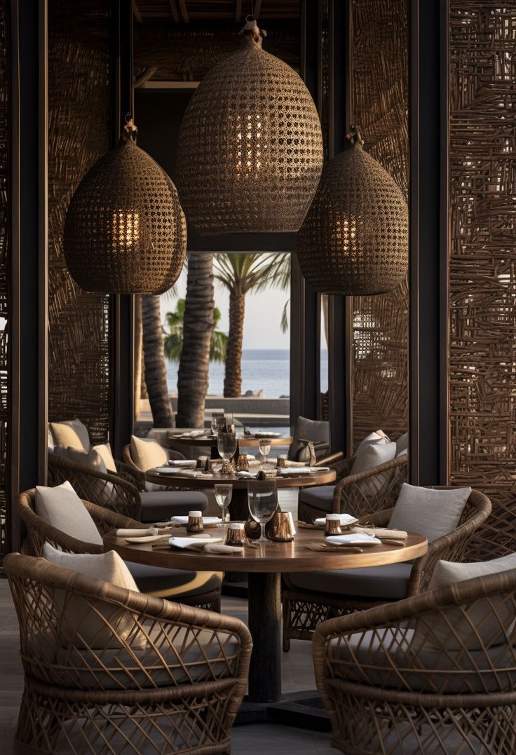 an outdoor dining area with wicker chairs and tables