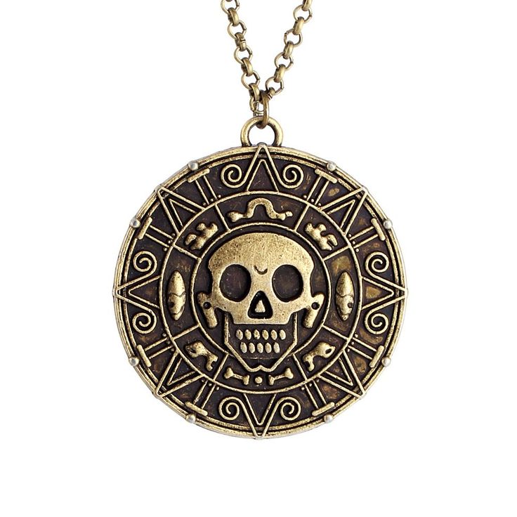 a gold necklace with a skull and crossbones on the front, in an ornate design