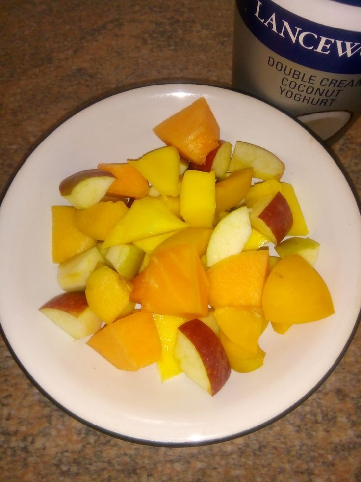 a white plate topped with cut up fruit next to a can of lanceway