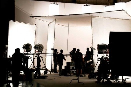 a group of people standing in front of white backdrops with lights on each side