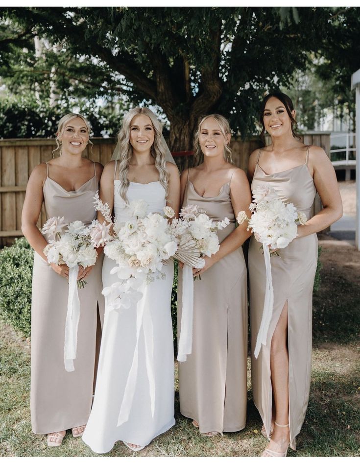 the bridesmaids are all dressed in different shades of beige and white bouquets