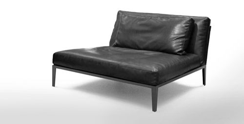 a black leather chair sitting on top of a white floor