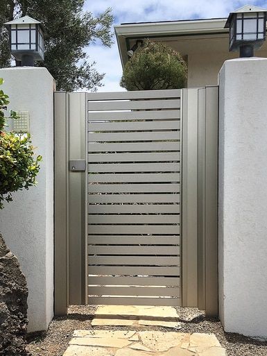 an entrance to a home with stone walkway