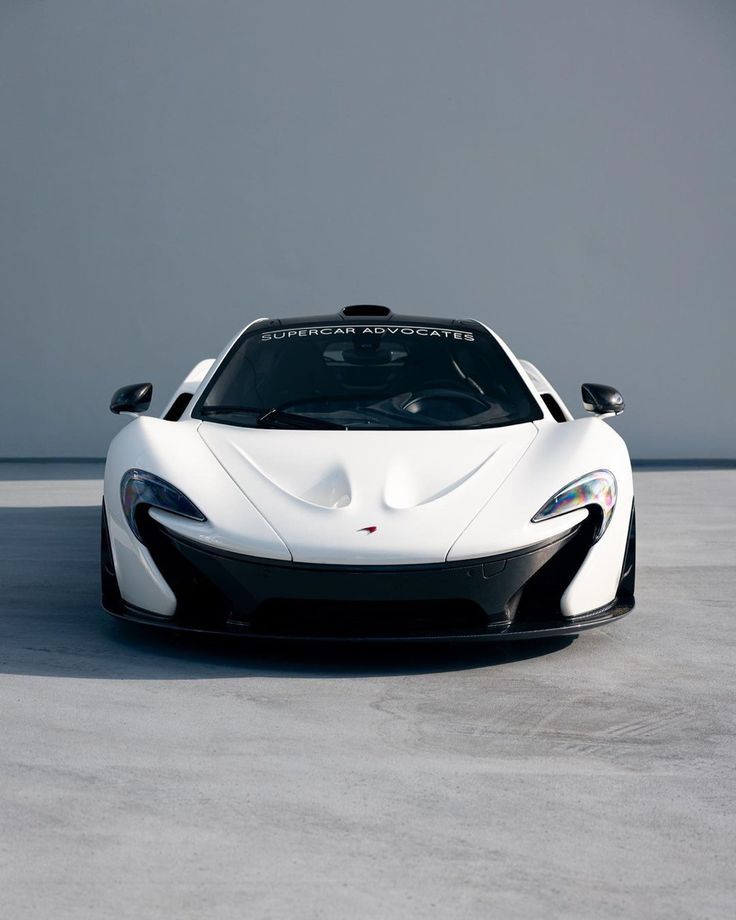 a white and black sports car parked in a parking lot