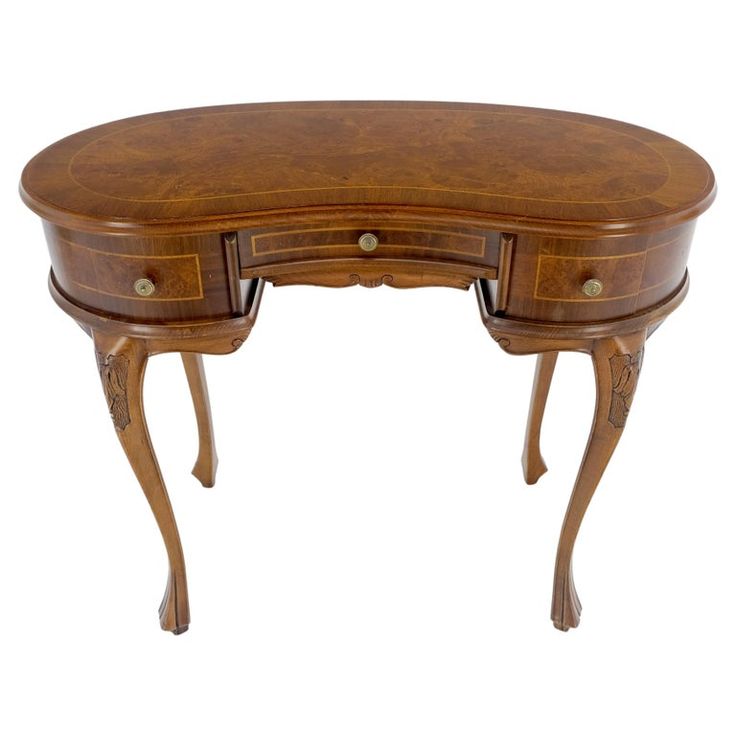 a wooden desk with two drawers on one side and an oval shaped drawer on the other