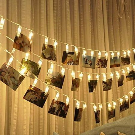 a string of lights that have pictures hanging from it's sides and are decorated with photos