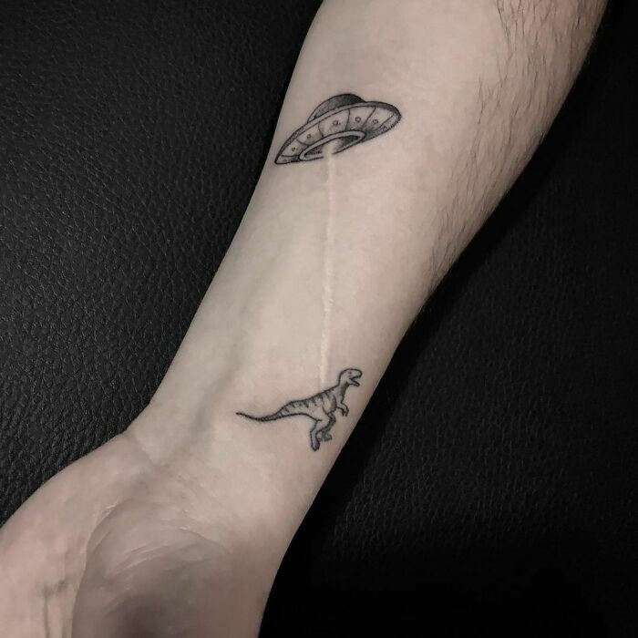 a person's arm with a tattoo on it and an image of a shark