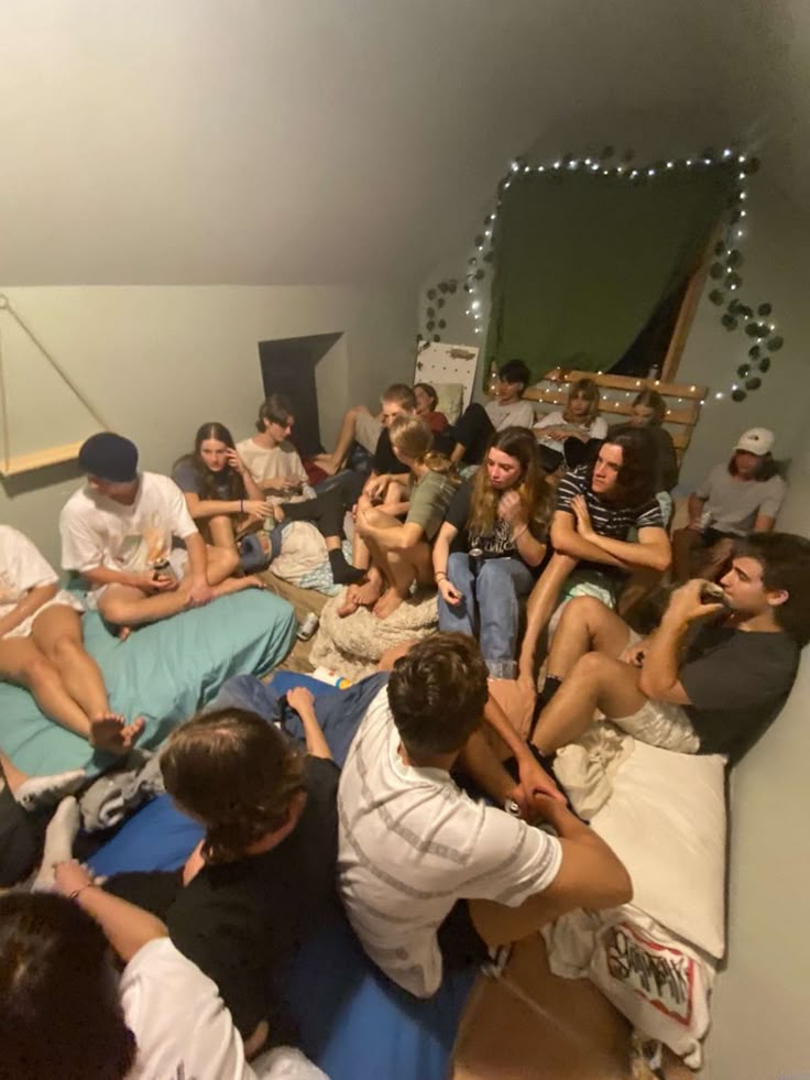 a group of people sitting on top of a bed in a room with white walls