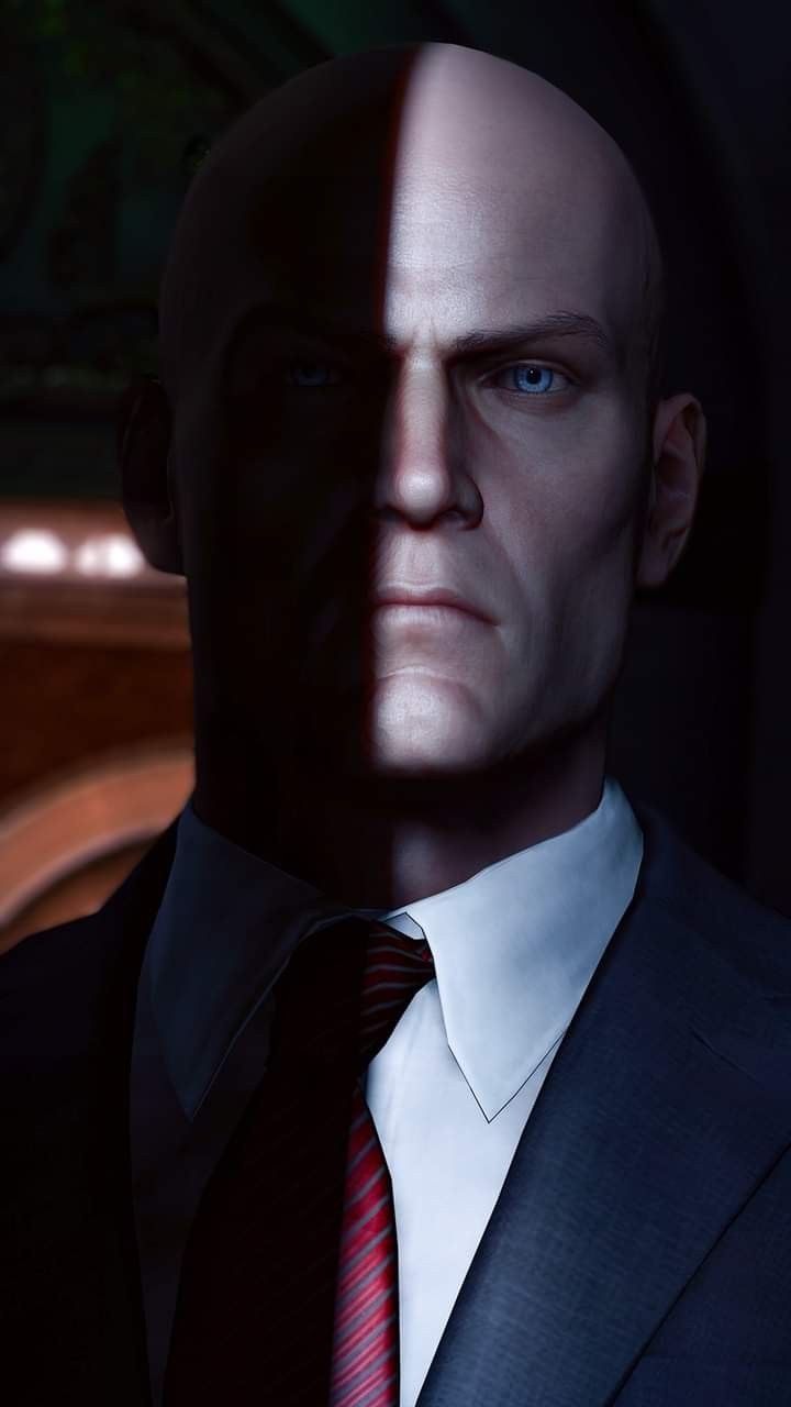 a man in a suit and red tie looking at the camera with an evil look on his face