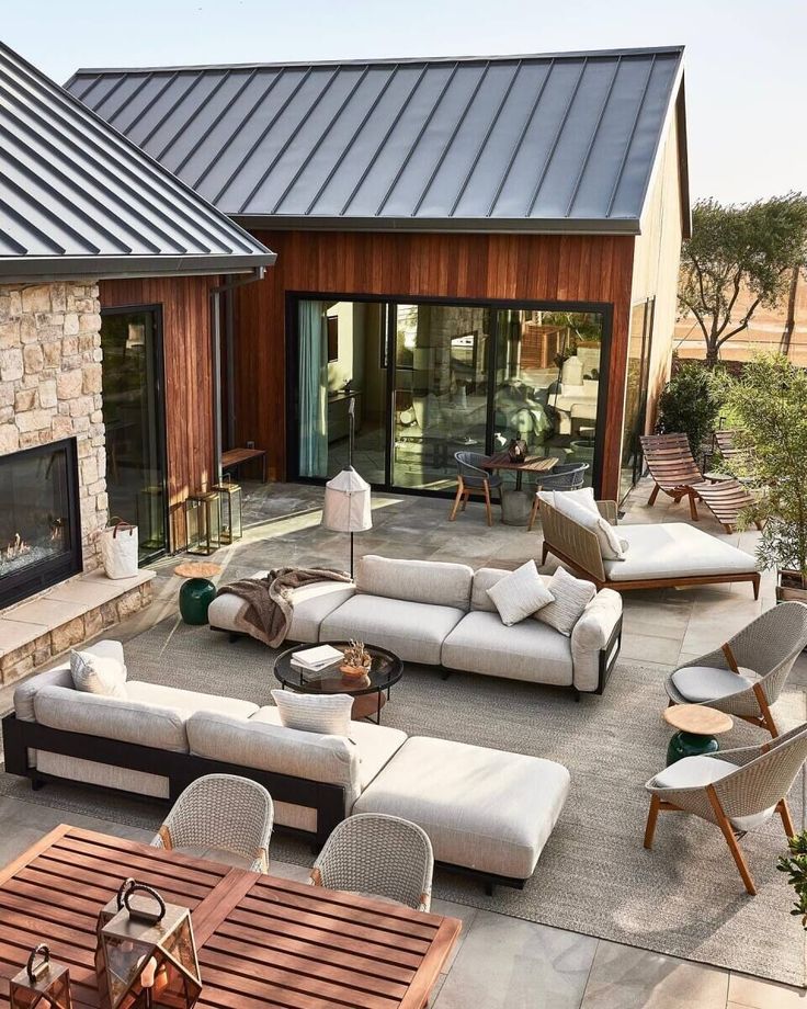 an outdoor living area with couches, tables and chairs