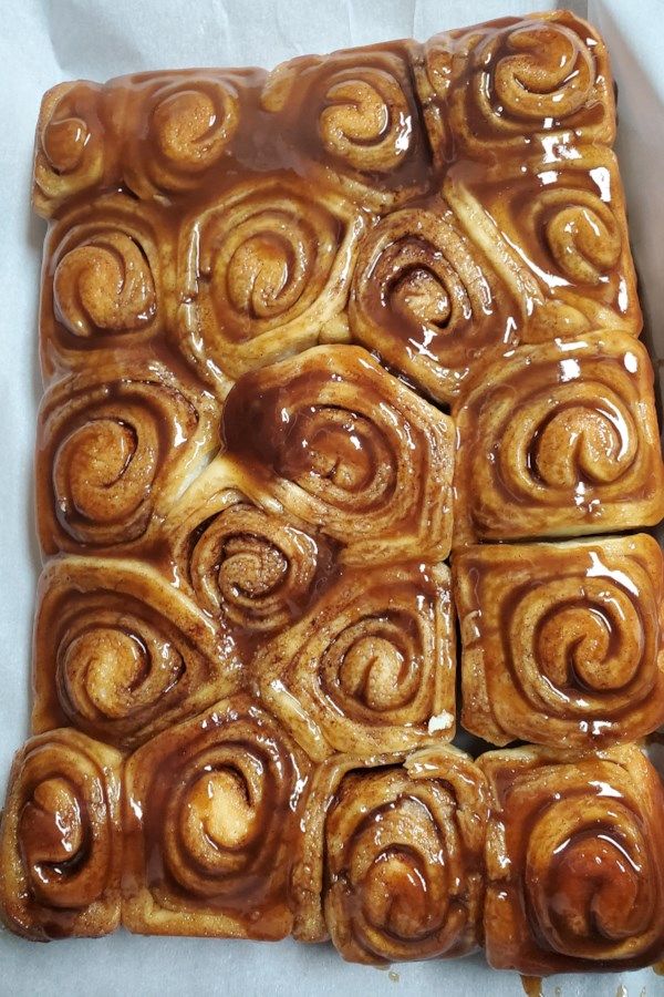 some cinnamon rolls sitting on top of a piece of paper