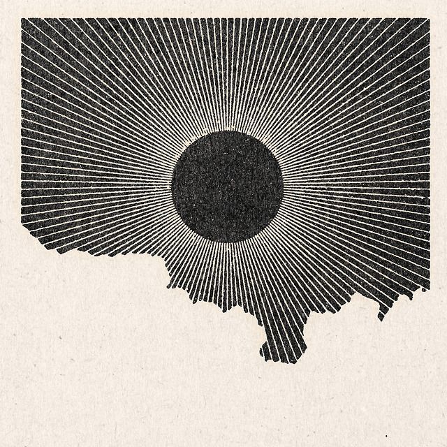 a black and white drawing of the shape of a sunburst over a map