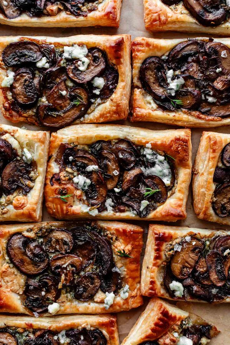 many square pizzas with mushrooms and cheese on them