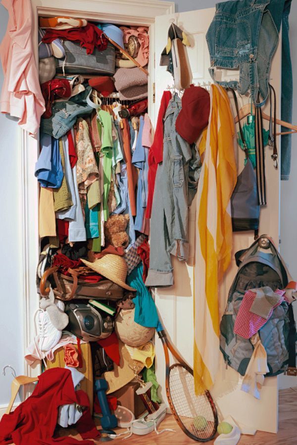 a closet filled with clothes and tennis rackets