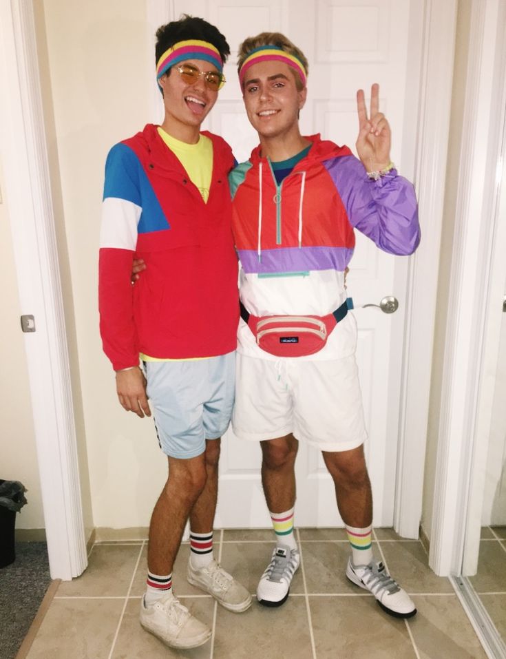 two young men standing next to each other in front of a door wearing headbands