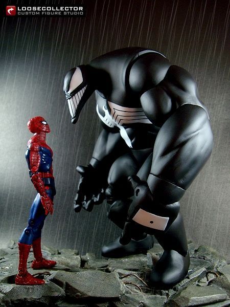 the spider - man is standing next to an action figure