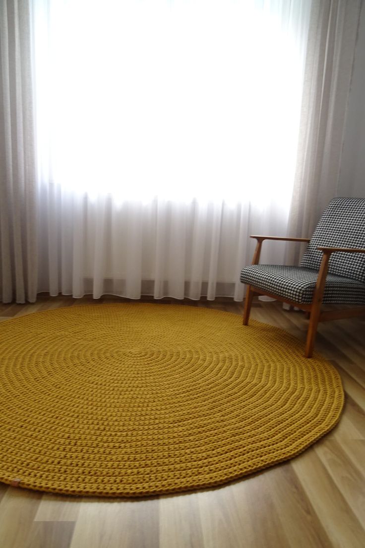 a large yellow rug in front of a window