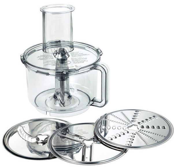 a food processor sitting on top of a white table next to a glass container with lid