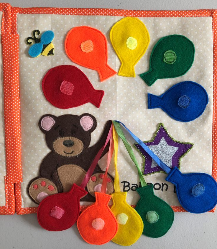 an assortment of felt toys are displayed on a wall