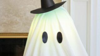 a ghost with a black hat on it's head