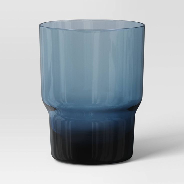 a blue glass sitting on top of a white table