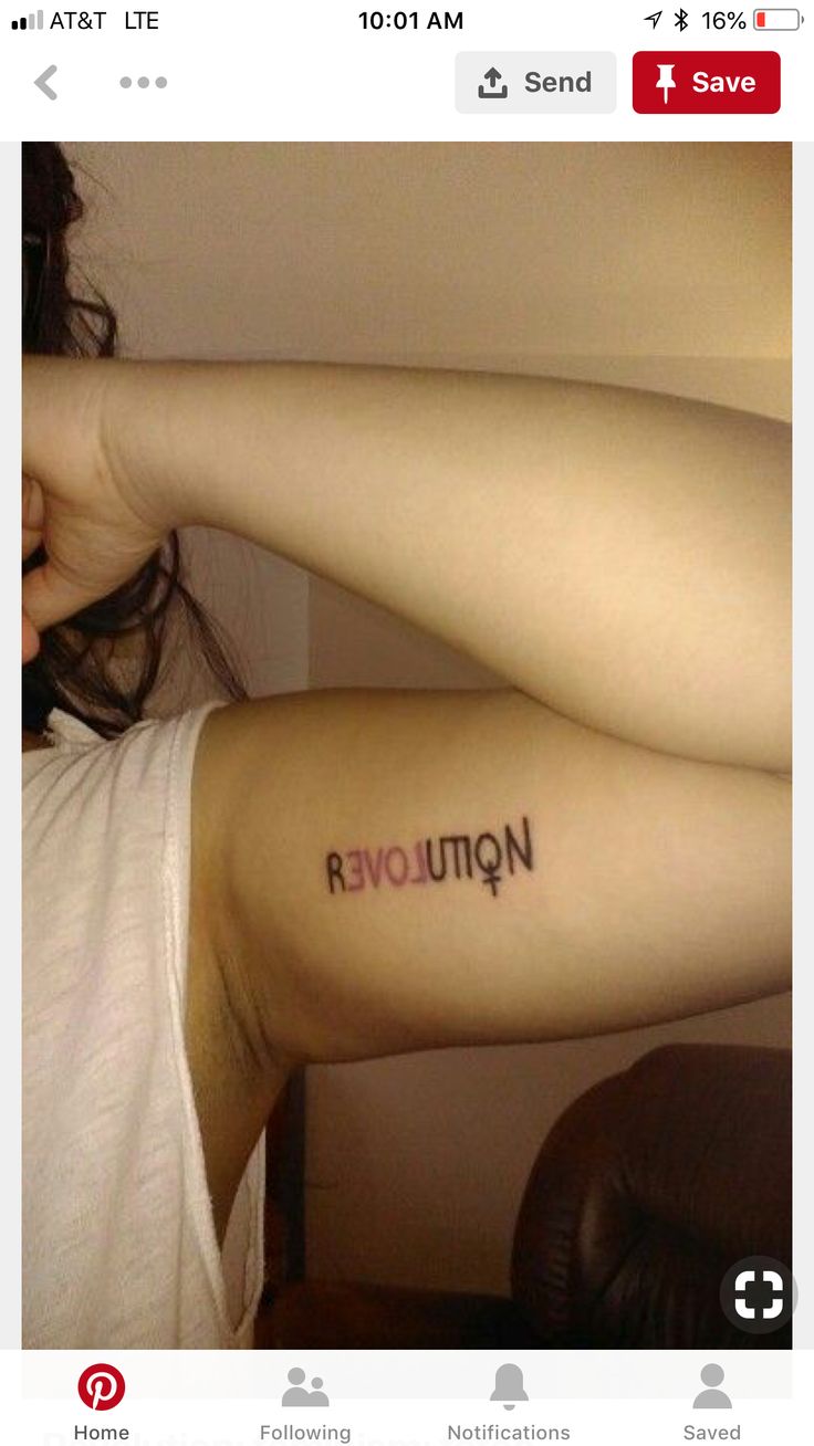 a woman with a tattoo on her arm that reads, notinovera in red ink