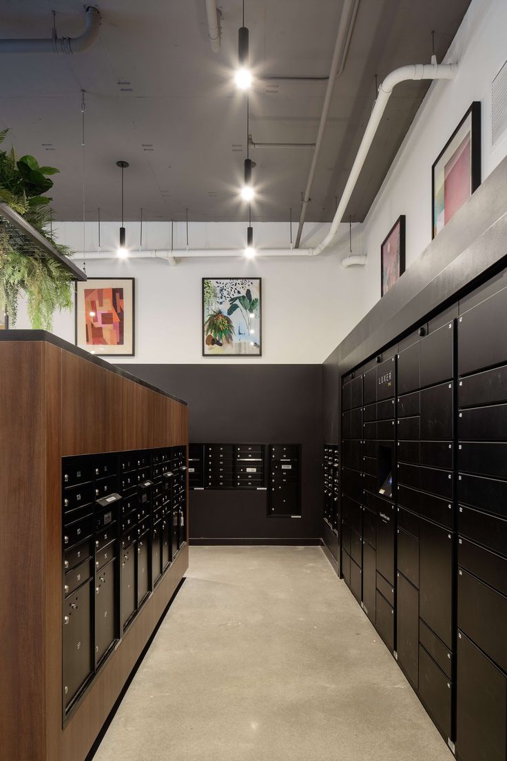 the lockers are lined up along the wall in the room with pictures on it