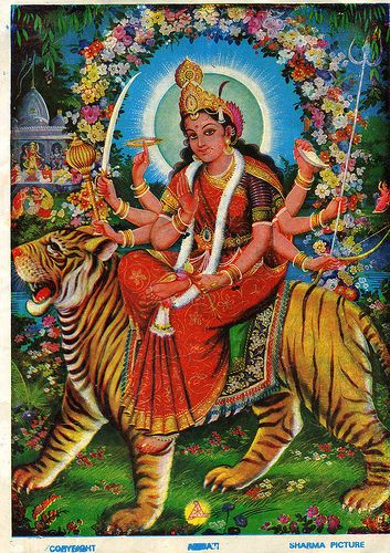 the hindu goddess sitting on top of a tiger