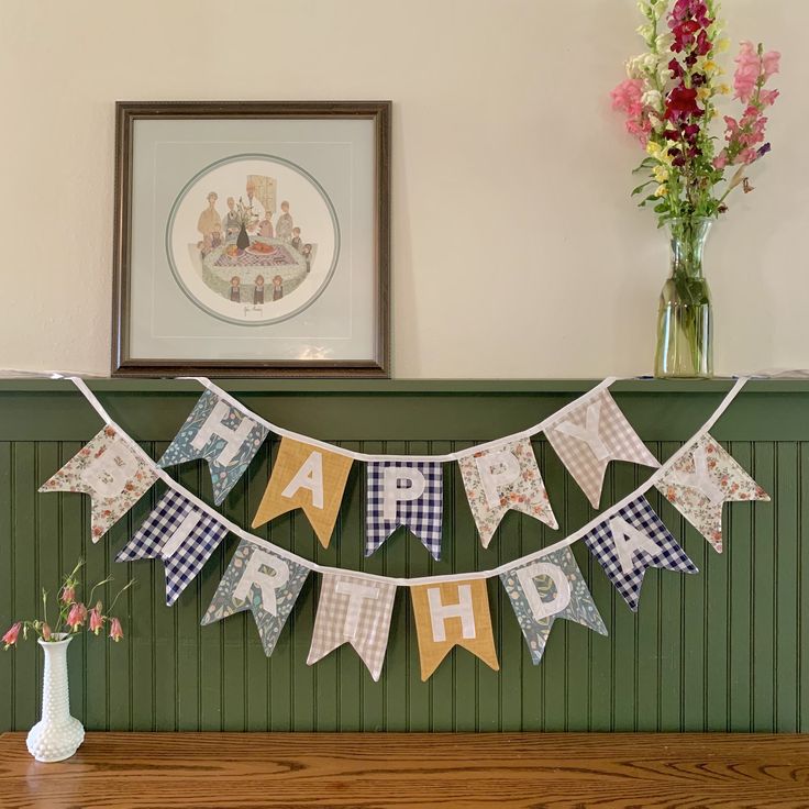 a happy birthday banner hanging from a mantle