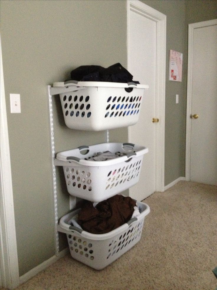 three laundry baskets stacked on top of each other in front of a door and closet