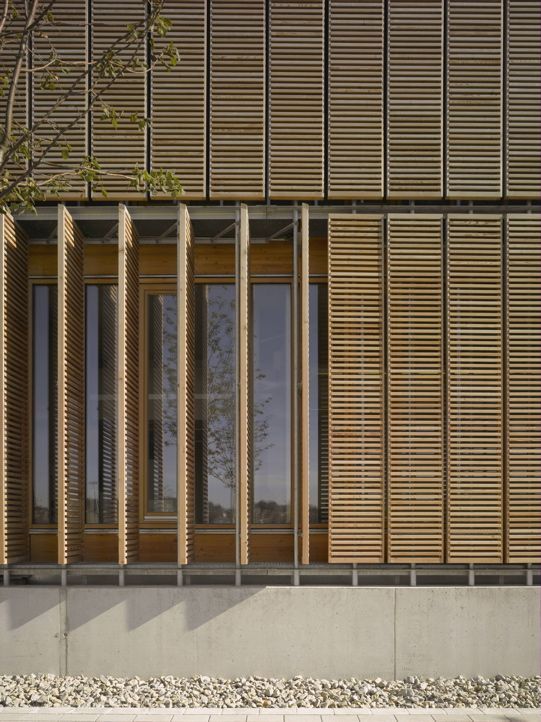 the side of a building with wooden slats on it's sides and windows