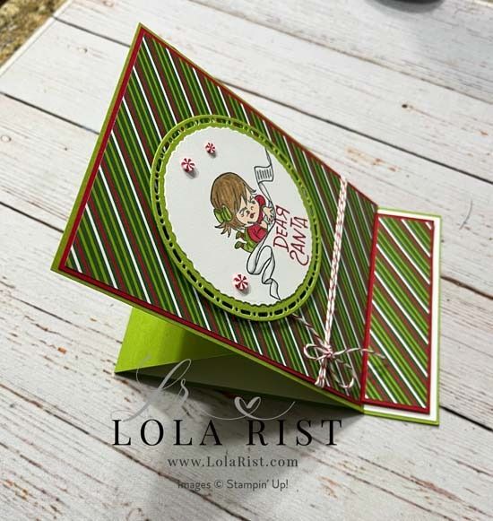 a close up of a card on a wooden table with a white and green background