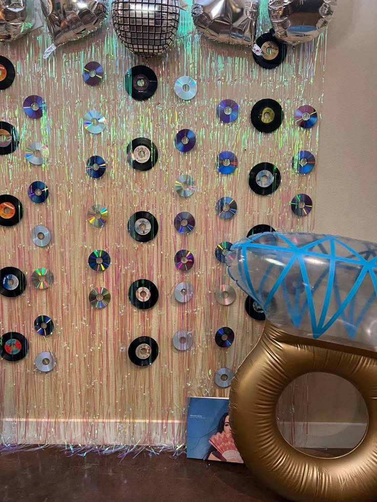 a room with balloons and disco balls on the wall