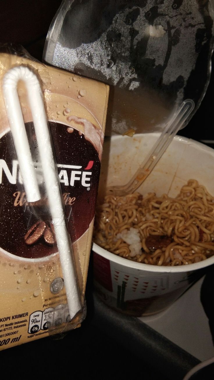 an unopened box of noodles next to a bowl of noodles