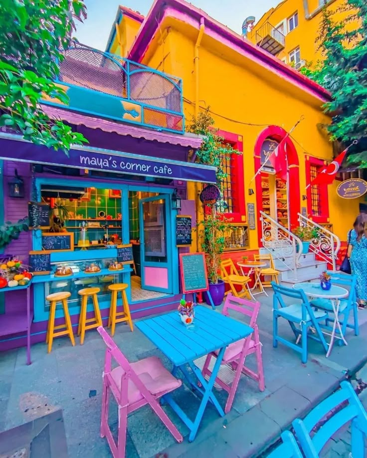 colorful tables and chairs in front of a building