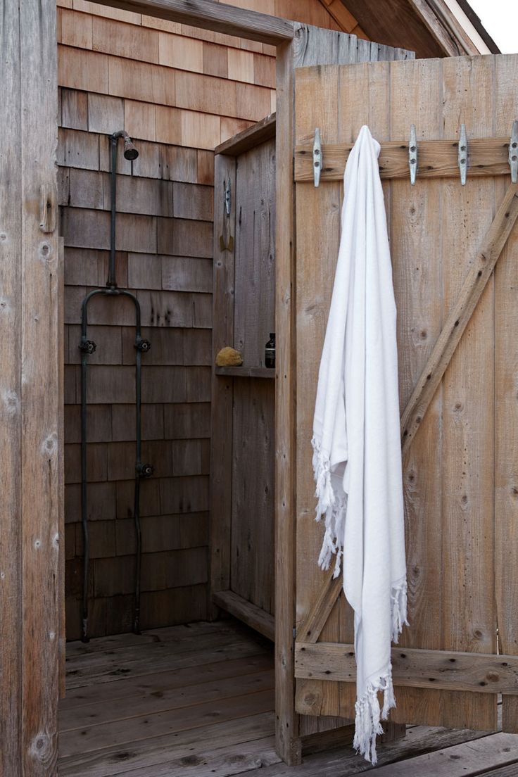 a white towel hanging on the side of a wooden door