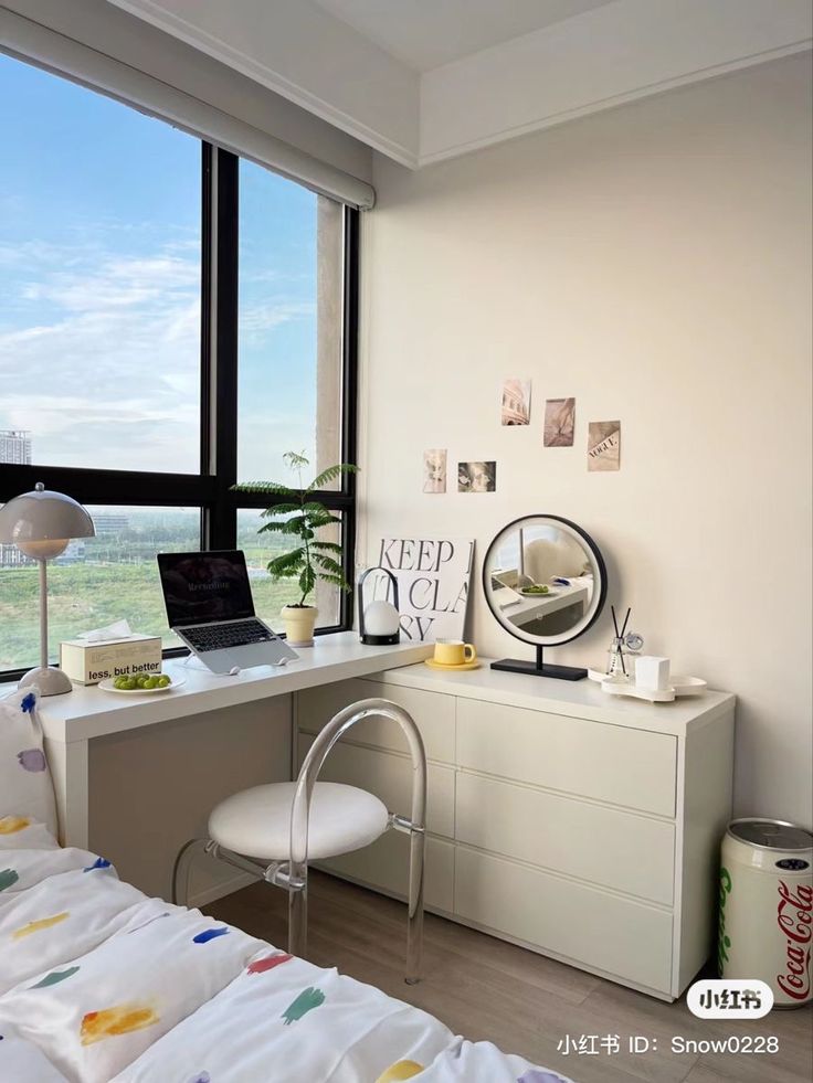 a bedroom with a desk, chair and large window