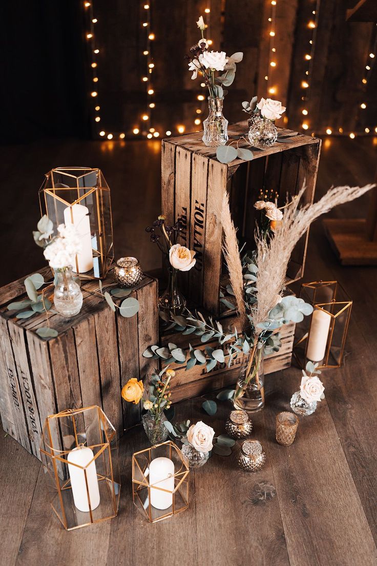 wooden crates with flowers and candles on them