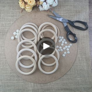 the scissors are sitting on top of the table next to some rubber o rings and beads