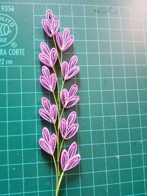 a purple flower on a green cutting board