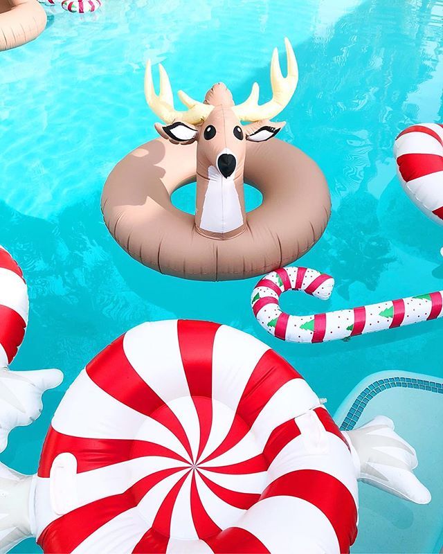 an inflatable pool float with reindeer head, candy canes and other decorations